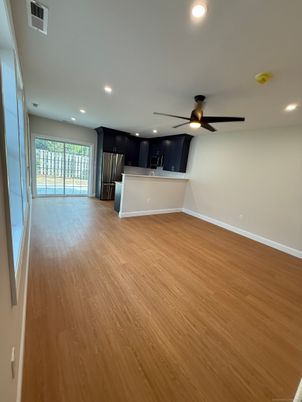Empty room, Interior, Kitchen, Recessed Lighting, Stainless Steel Appliances, Wood Texture Flooring