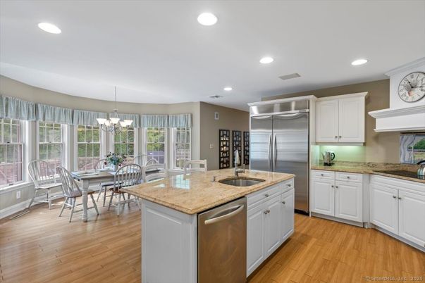 Chandelier, Dining room, Interior, Kitchen, Recessed Lighting, Stainless Steel Appliances, Wood Texture Flooring