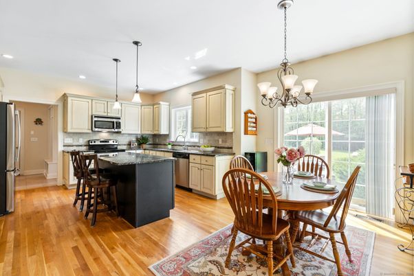 Chandelier, Dining room, Interior, Kitchen, Pendant Lights, Recessed Lighting, Stainless Steel Appliances, Wood Texture Flooring