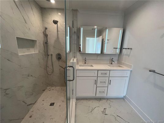 Bathroom, Dual Sink Vanities, Glass Shower, Interior, Marble, Marble Walls, Recessed Lighting