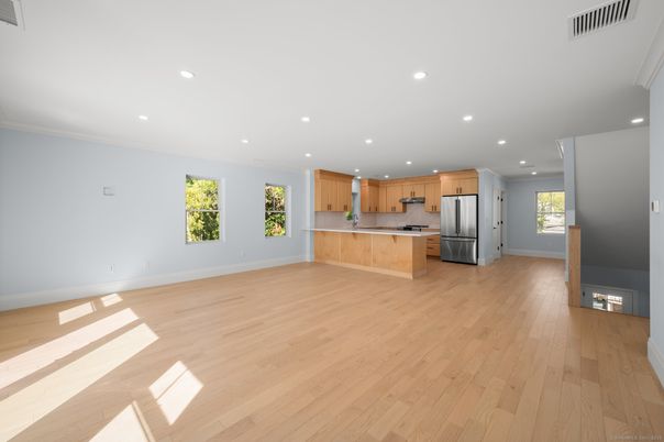Empty room, Interior, Kitchen, Recessed Lighting, Stainless Steel Appliances, Wood Texture Flooring