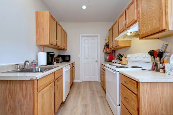 Interior, Kitchen, Recessed Lighting, Tile Countertops, Wood Texture Flooring