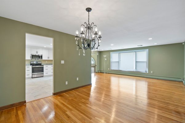 Chandelier, Empty room, Interior, Kitchen, Recessed Lighting, Stainless Steel Appliances, Wood Texture Flooring