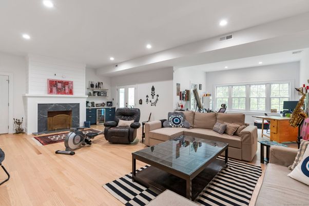 Fireplace, Fitness Equipment, Interior, Living room, Recessed Lighting, Wood Texture Flooring