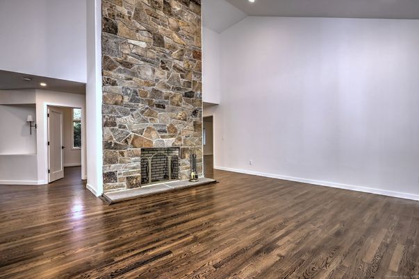 Empty room, Fireplace, Interior, Recessed Lighting, Stone Walls, Wood Texture Flooring