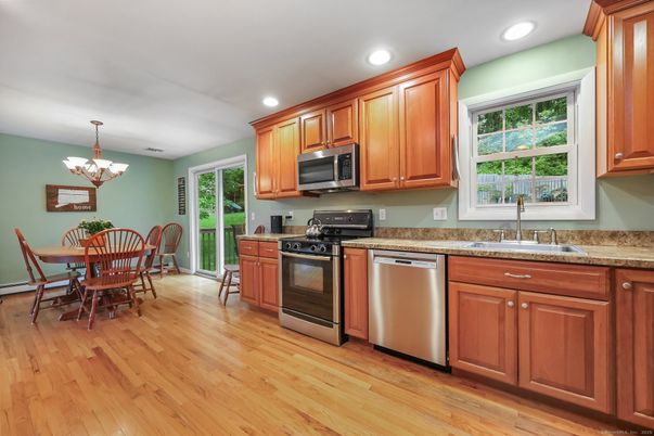 Chandelier, Dining room, Interior, Kitchen, Recessed Lighting, Stainless Steel Appliances, Wood Texture Flooring