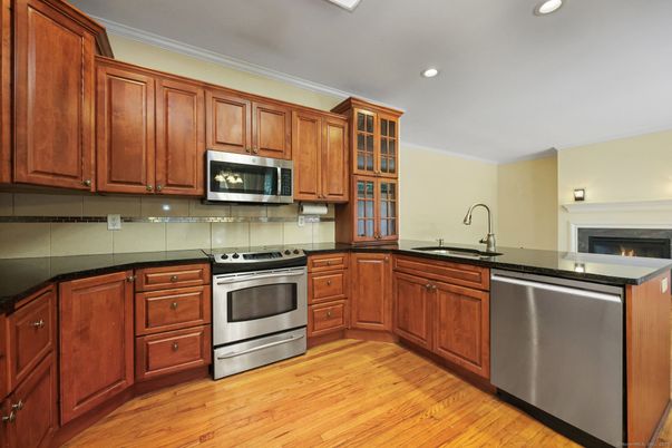 Fireplace, Interior, Kitchen, Recessed Lighting, Stainless Steel Appliances, Wood Texture Flooring