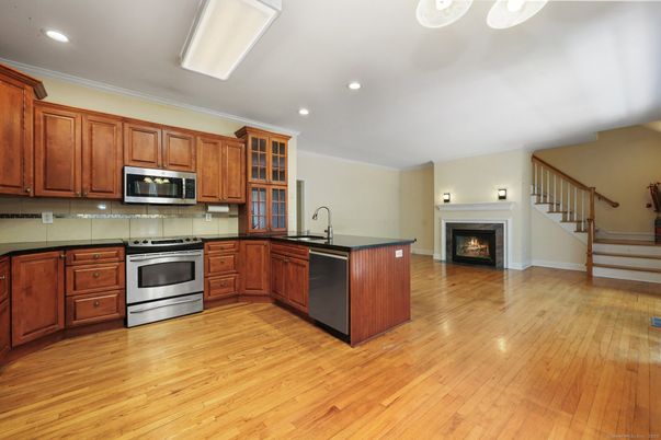 Fireplace, Interior, Kitchen, Recessed Lighting, Stainless Steel Appliances, Wood Texture Flooring