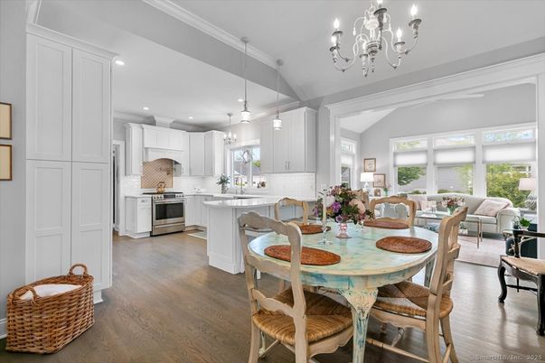 Chandelier, Dining room, Interior, Kitchen, Living room, Pendant Lights, Recessed Lighting, Stainless Steel Appliances, Wood Texture Flooring