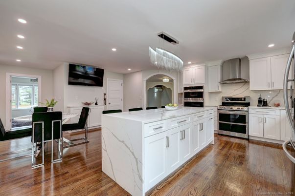 Chandelier, Dining room, Interior, Kitchen, Recessed Lighting, Stainless Steel Appliances, Wood Texture Flooring