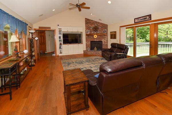 Fireplace, Interior, Living room, Recessed Lighting, Stone Walls, Wood Texture Flooring
