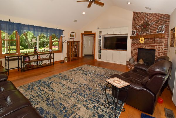 Fireplace, Interior, Living room, Recessed Lighting, Stone Walls, Wood Texture Flooring
