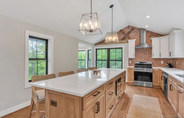 Fireplace, Interior, Kitchen, Pendant Lights, Recessed Lighting, Stainless Steel Appliances, Stone Walls, Wood Texture Flooring