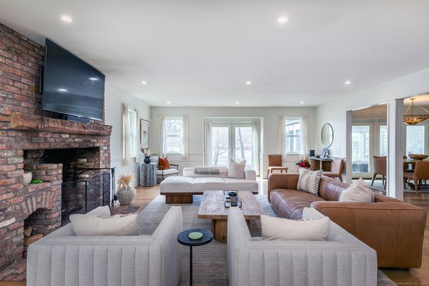 Dining room, Fireplace, Interior, Living room, Recessed Lighting, Stone Walls, Wood Texture Flooring