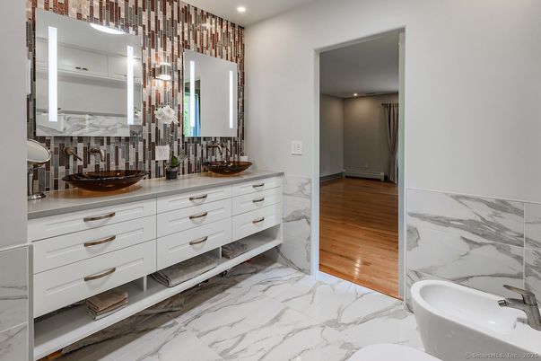 Bathroom, Dual Sink Vanities, Free Standing Baths, Interior, Marble, Marble Walls, Recessed Lighting, Wood Texture Flooring