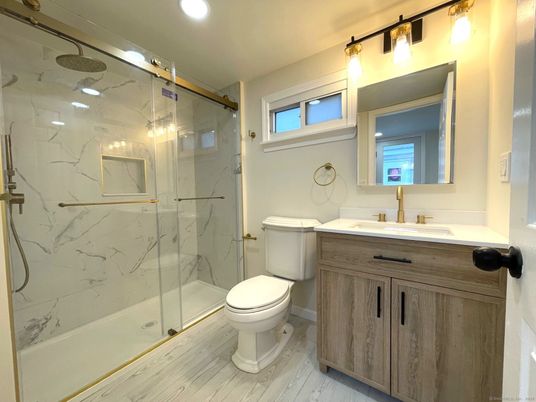 Bathroom, Glass Shower, Interior, Marble Walls, Recessed Lighting, Wood Texture Flooring