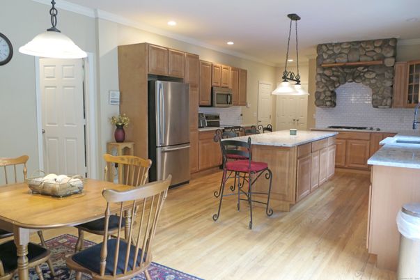 Interior, Kitchen, Pendant Lights, Recessed Lighting, Stainless Steel Appliances, Stone Walls, Wood Texture Flooring