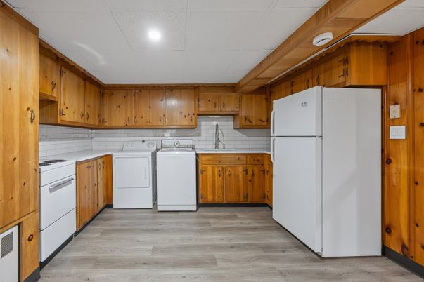 Interior, Kitchen, Recessed Lighting, Washer, Wood Texture Flooring, Wooden Walls