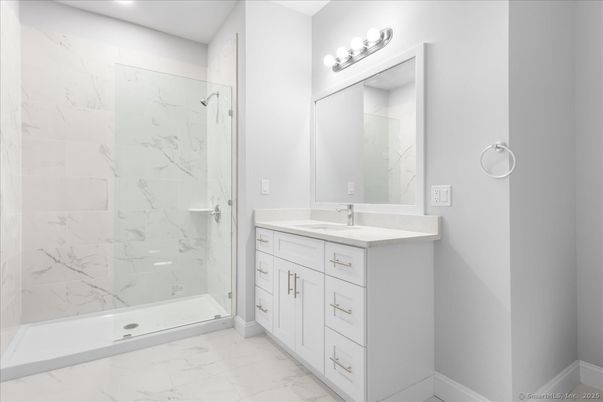 Bathroom, Dual Sink Vanities, Glass Shower, Interior, Marble, Marble Walls, Recessed Lighting