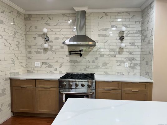 Interior, Kitchen, Marble Walls, Recessed Lighting, Stainless Steel Appliances, Wood Texture Flooring