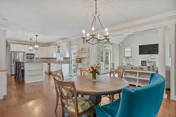 Chandelier, Dining room, Fireplace, Interior, Kitchen, Pendant Lights, Stainless Steel Appliances, Wood Texture Flooring