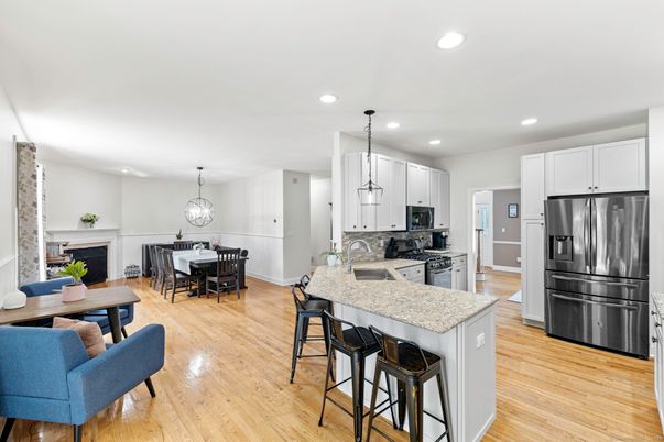 Dining room, Fireplace, Interior, Kitchen, Pendant Lights, Recessed Lighting, Stainless Steel Appliances, Wood Texture Flooring