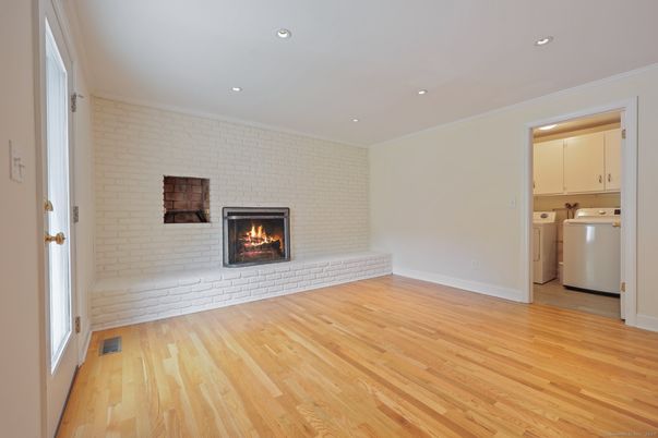 Empty room, Fireplace, Interior, Recessed Lighting, Stone Walls, Washer, Wood Texture Flooring