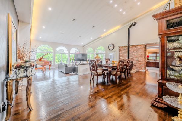 Dining room, Fireplace, Interior, Living room, Recessed Lighting, Stone Walls, Wood Texture Flooring