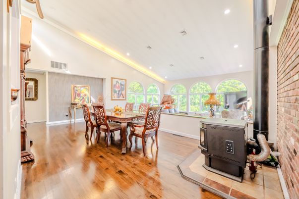 Dining room, Fireplace, Interior, Recessed Lighting, Stone Walls, Wood Texture Flooring