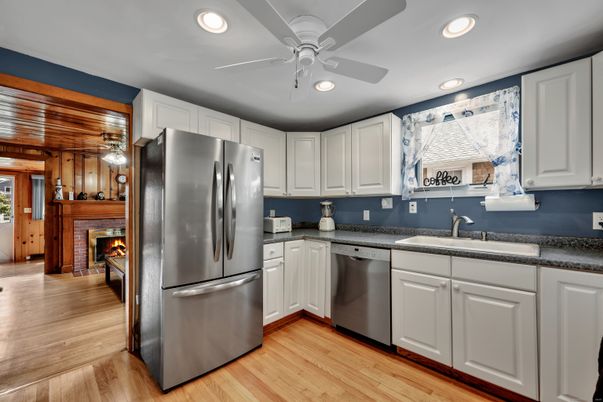 Fireplace, Interior, Kitchen, Recessed Lighting, Stainless Steel Appliances, Wood Texture Flooring, Wooden Walls