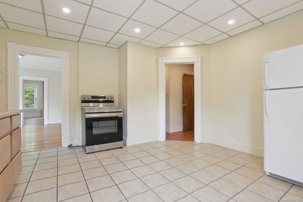 Empty room, Interior, Kitchen, Recessed Lighting, Stainless Steel Appliances, Wood Texture Flooring