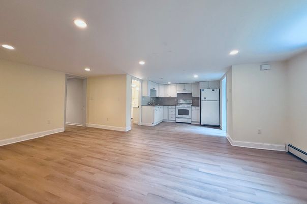 Empty room, Interior, Kitchen, Recessed Lighting, Stainless Steel Appliances, Wood Texture Flooring