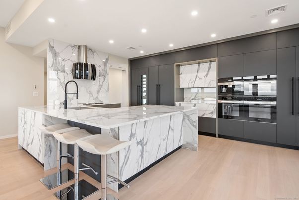 Interior, Kitchen, Marble Walls, Recessed Lighting, Stainless Steel Appliances, Wood Texture Flooring