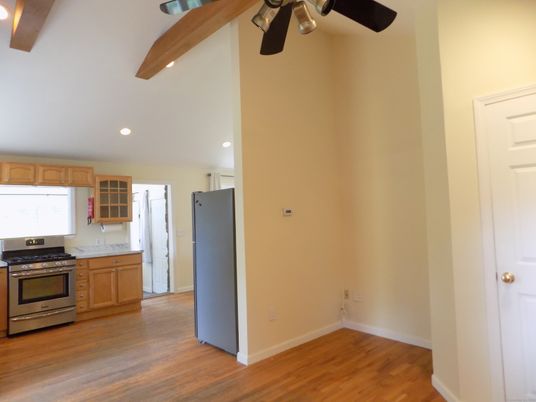 Empty room, Interior, Kitchen, Recessed Lighting, Stainless Steel Appliances, Wood Texture Flooring