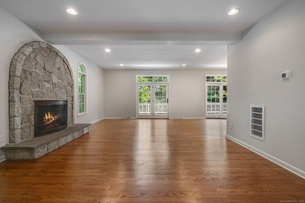 Empty room, Fireplace, Interior, Recessed Lighting, Stone Walls, Wood Texture Flooring