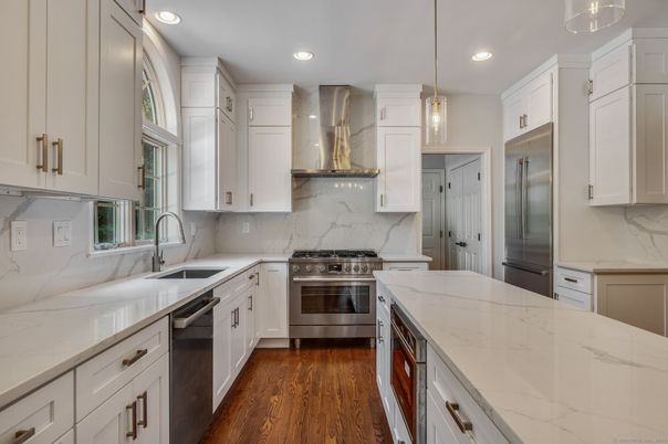 Interior, Kitchen, Marble Walls, Pendant Lights, Recessed Lighting, Stainless Steel Appliances, Wood Texture Flooring