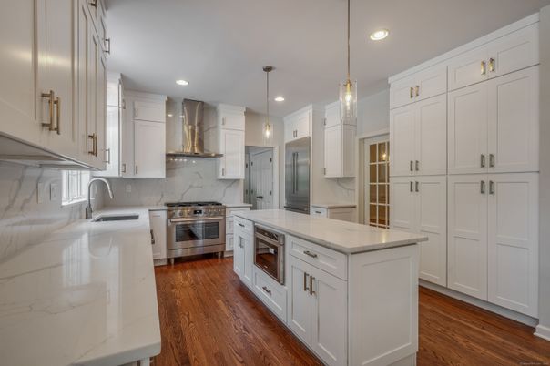 Interior, Kitchen, Marble Walls, Pendant Lights, Recessed Lighting, Stainless Steel Appliances, Wood Texture Flooring