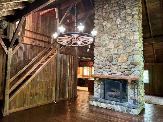 Chandelier, Fireplace, Interior, Pendant Lights, Stone Walls, Wood Texture Flooring
