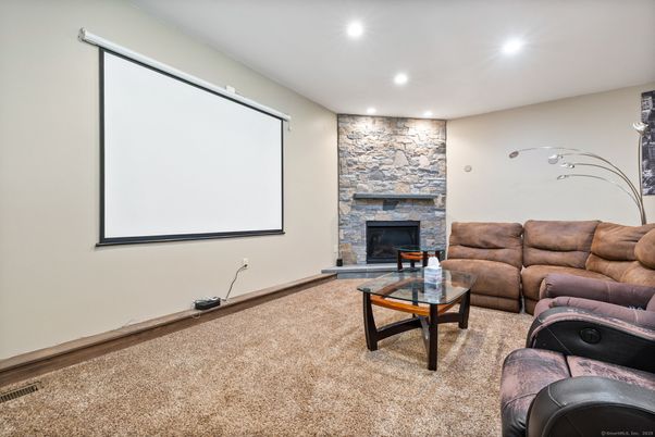Fireplace, Interior, Living room, Projection Screen, Recessed Lighting, Stone Walls