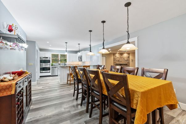 Dining room, Interior, Kitchen, Pendant Lights, Recessed Lighting, Stainless Steel Appliances, Stone Walls, Wood Texture Flooring