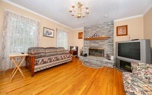 Chandelier, Fireplace, Interior, Recessed Lighting, Stone Walls, Wood Texture Flooring