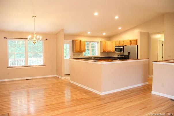 Chandelier, Empty room, Interior, Kitchen, Pendant Lights, Recessed Lighting, Stainless Steel Appliances, Wood Texture Flooring