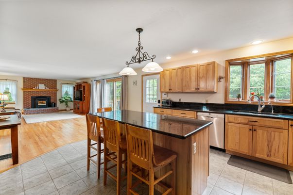 Fireplace, Interior, Kitchen, Pendant Lights, Recessed Lighting, Stainless Steel Appliances, Stone Walls, Wood Texture Flooring
