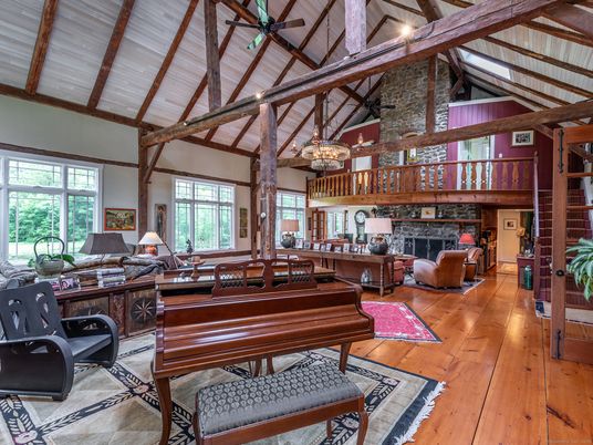 Chandelier, Fireplace, Interior, Living room, Piano, Stone Walls, Wooden Beams, Wood Texture Flooring