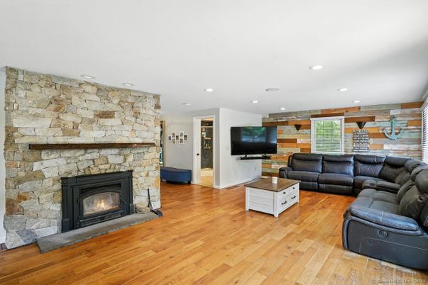 Fireplace, Interior, Living room, Recessed Lighting, Stone Walls, Wood Texture Flooring