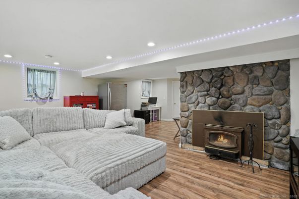 Fireplace, Interior, Living room, Recessed Lighting, Stone Walls, Wood Texture Flooring
