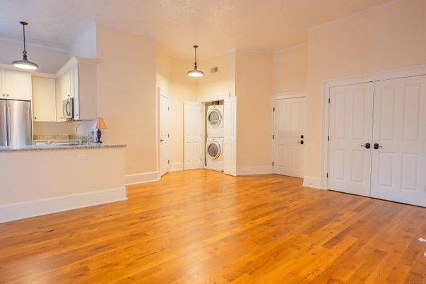 Empty room, Interior, Kitchen, Pendant Lights, Stainless Steel Appliances, Washer, Wood Texture Flooring