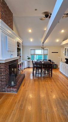 Chandelier, Dining room, Fireplace, Interior, Recessed Lighting, Stone Walls, Wood Texture Flooring