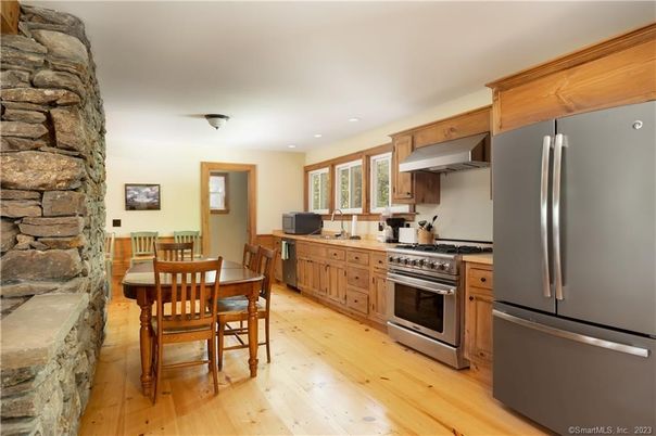 Dining room, Interior, Kitchen, Recessed Lighting, Stainless Steel Appliances, Stone Walls, Wood Texture Flooring