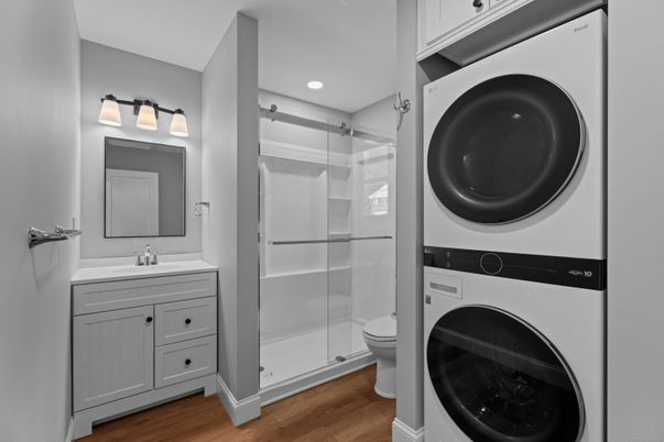 Bathroom, Glass Shower, Interior, Recessed Lighting, Washer, Wood Texture Flooring